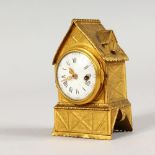 A MINIATURE ORMOLU CLOCK, modelled as a half timbered building with thatched roof. 3.25ins high.