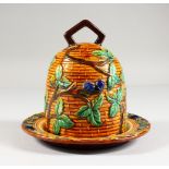 A MAJOLICA STYLE BEEHIVE CHEESE DOME AND STAND. 7ins high.