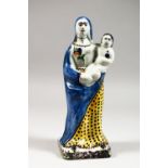 A CONTINENTAL FAIENCE POTTERY MODEL OF A MADONNA AND CHILD. 10.5ins high.