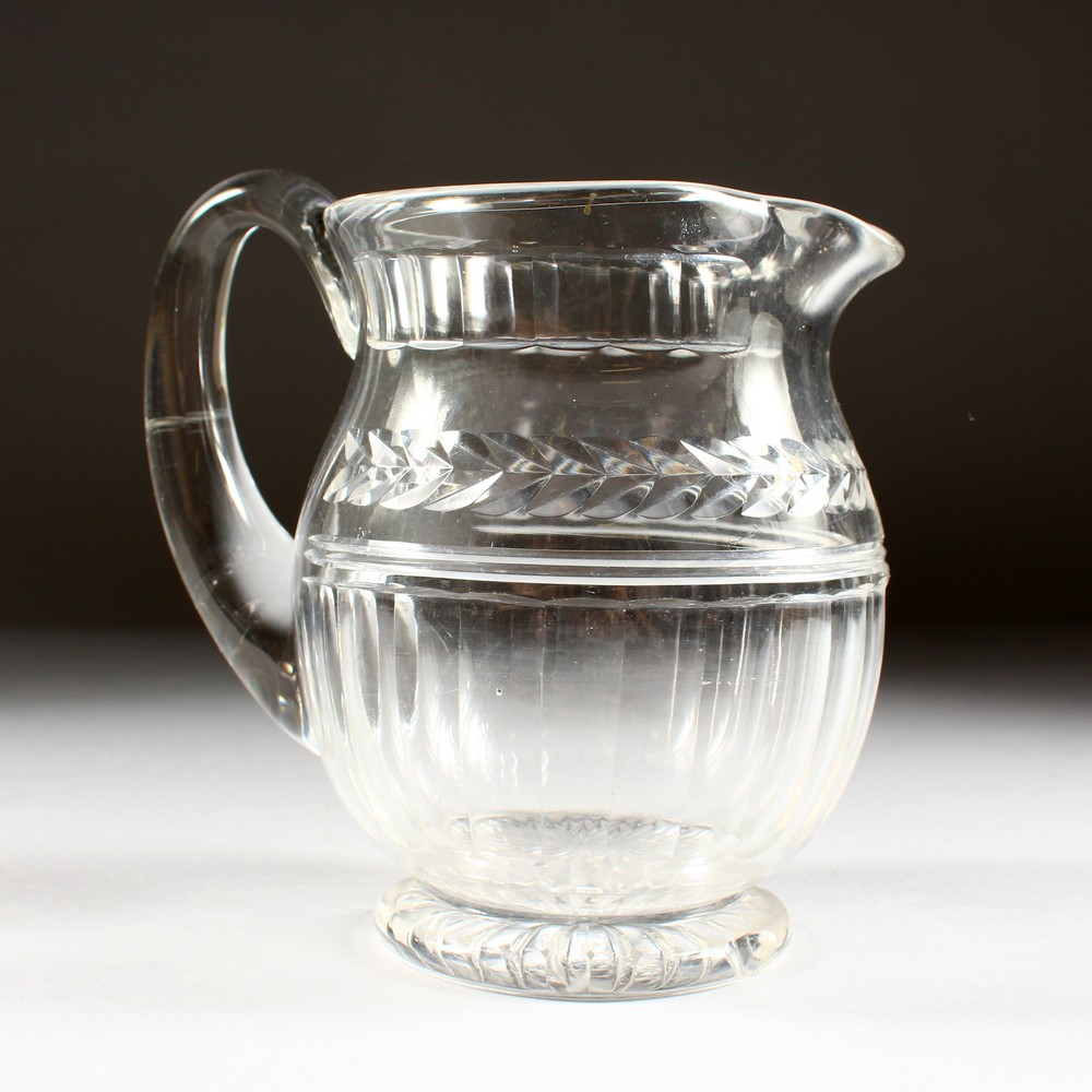 A DEEP CUT GLASS JUG.