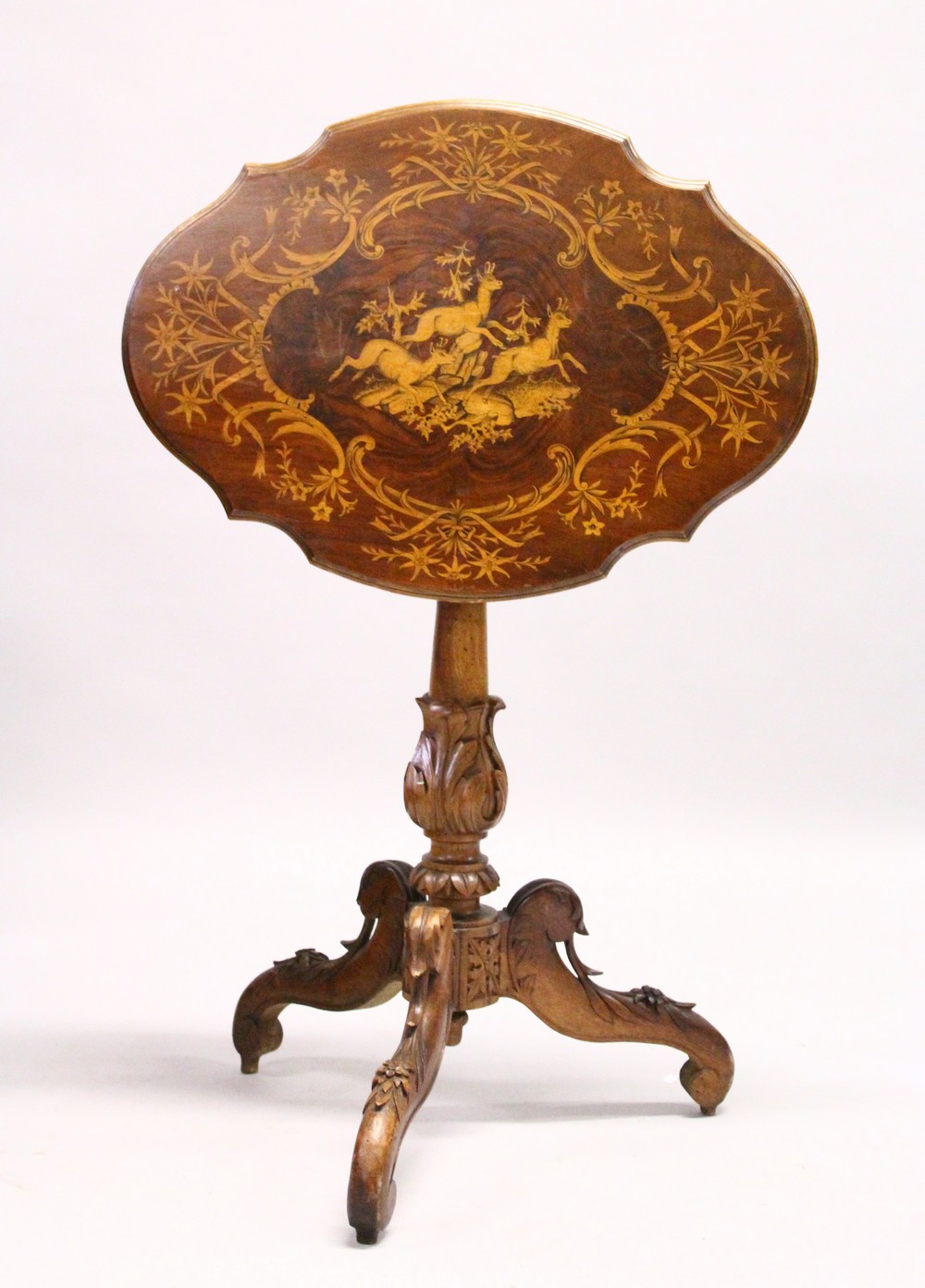 A "BLACK FOREST" WALNUT AND MARQUETRY TRIPOD TABLE, the shaped top inlaid with a scene of mountain