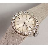 A LADIES 18CT GOLD AND DIAMOND LONGINES WRISTWATCH.