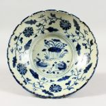 A BLUE AND WHITE POTTERY BOWL, painted with ducks and flowers. 8.25ins diameter.