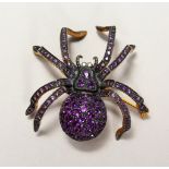 A 9CT GOLD AND SILVER SPIDER BROOCH, set with amethyst and diamonds.