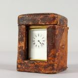 A GOOD QUALITY SMALL BRASS CARRIAGE CLOCK. 3ins high, in a leather carrying case.
