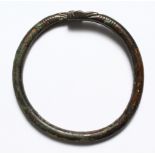 A ROMAN BRONZE BANGLE WITH SNAKE HEAD.