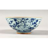 A SMALL BLUE AND WHITE PORCELAIN BOWL, painted with figures and flowers. 5ins high.