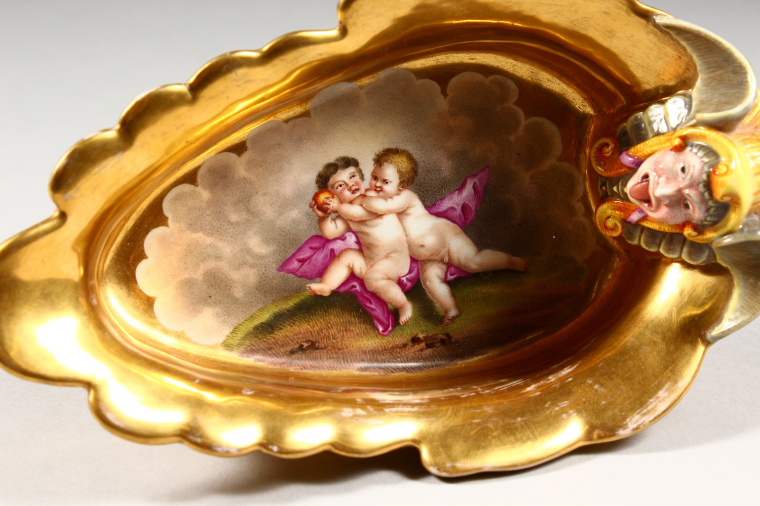 A BERLIN GILT PORCELAIN SAUCEBOAT, with grotesque mask, the centre painted with cupids. 8ins - Image 3 of 11