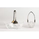 A PAIR OF SILVER MOUNTED CUT GLASS BOAT SHAPED DISHES, possibly Russian, with swing handles. 9.25ins