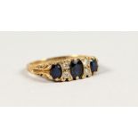 AN 18CT GOLD, SAPPHIRE AND DIAMOND RING.
