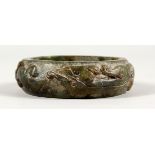 A GOOD LARGE CARVED DEEP GREEN JADE BANGLE.