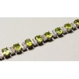 A SILVER REAL PERIDOT LINE BRACELET.