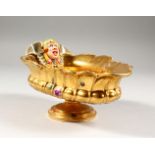 A BERLIN GILT PORCELAIN SAUCEBOAT, with grotesque mask, the centre painted with cupids. 8ins