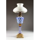 A 19TH CENTURY BOHEMIAN BLUE AND WHITE OVERLAY OIL LAMP, with reservoir and stem, with white glass