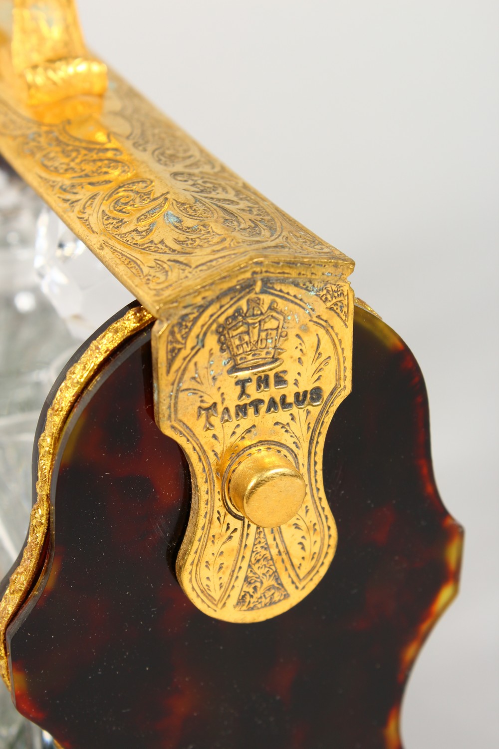 A MINIATURE FAUX TORTOISESHELL AND ORMOLU MOUNTED TANTALUS. 10.5ins wide. - Image 2 of 3