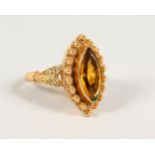A 9CT GOLD CITRINE MARQUISE RING.