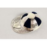 A NOVELTY SILVER JOCKEY CAP PIN CUSHION.