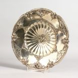 AN ART NOUVEAU CIRCULAR DISH with panels of flowers. Stamped .800. 10ins diameter.