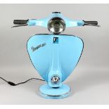 A LARGE NVOELTY BLUE PAINTED METAL LAMP, modelled as the front end if a Vespa scooter. 25ins high