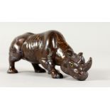 A POSSIBLY FABERGE CARVED HARDSTONE RHINOCEROS, head pointing downwards, with emerald eyes. 4.