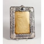 A PIERCED CROSSHATCH SILVER PHOTOGRAPH FRAME. 11ins x 8.5ins.