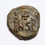 AN OLD METAL ROMAN COIN.