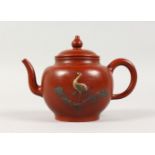 A SMALL TERRACOTTA TEAPOT, with moulded stork decoration. 6.5ins wide.