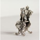 A NOVELTY SILVER CAT ON A CHAIR. 1.75ins high.