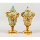 A VERY GOOD PAIR OF FELDSPAR AND ORMOLU URNS, with turned covers, Bacchus mask handles and grape and