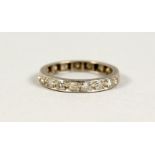 A GOLD AND DIAMOND ETERNITY RING.