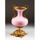 A PINK GLASS AND BRASS TWO-HANDLED VASE. 12ins high.
