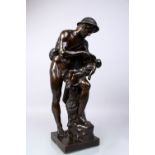 AFTER THE RENAISSANCE A 19TH CENTURY BRONZE OF A MAN feeding a baby, a dog at his feet, on a
