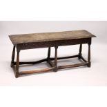 AN 18TH/19TH CENTURY OAK BENCH, with moulded rectangular top, carved frieze on six turned and