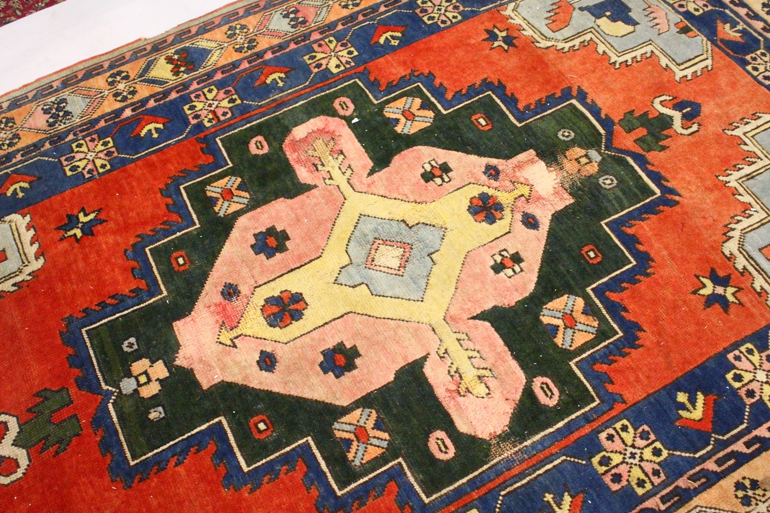 A PERSIAN RUG, 20TH CENTURY, bright red ground with large stylised design, within a similar double - Image 2 of 11