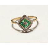 A 9CT GOLD ART DECO DESIGN EMERALD AND DIAMOND RING.