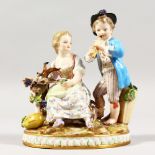 A VERY GOOD 19TH CENTURY PORCELAIN GROUP of a boy and girl with a goat, fruit and vines. Cross