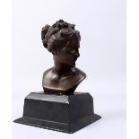 A CLASSICAL BRONZE FEMALE BUST, on a square bronze base. 7.5ins high.