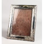 A SCROLL EDGE SILVER PHOTOGRAPH FRAME. 8.5ins x 7ins.