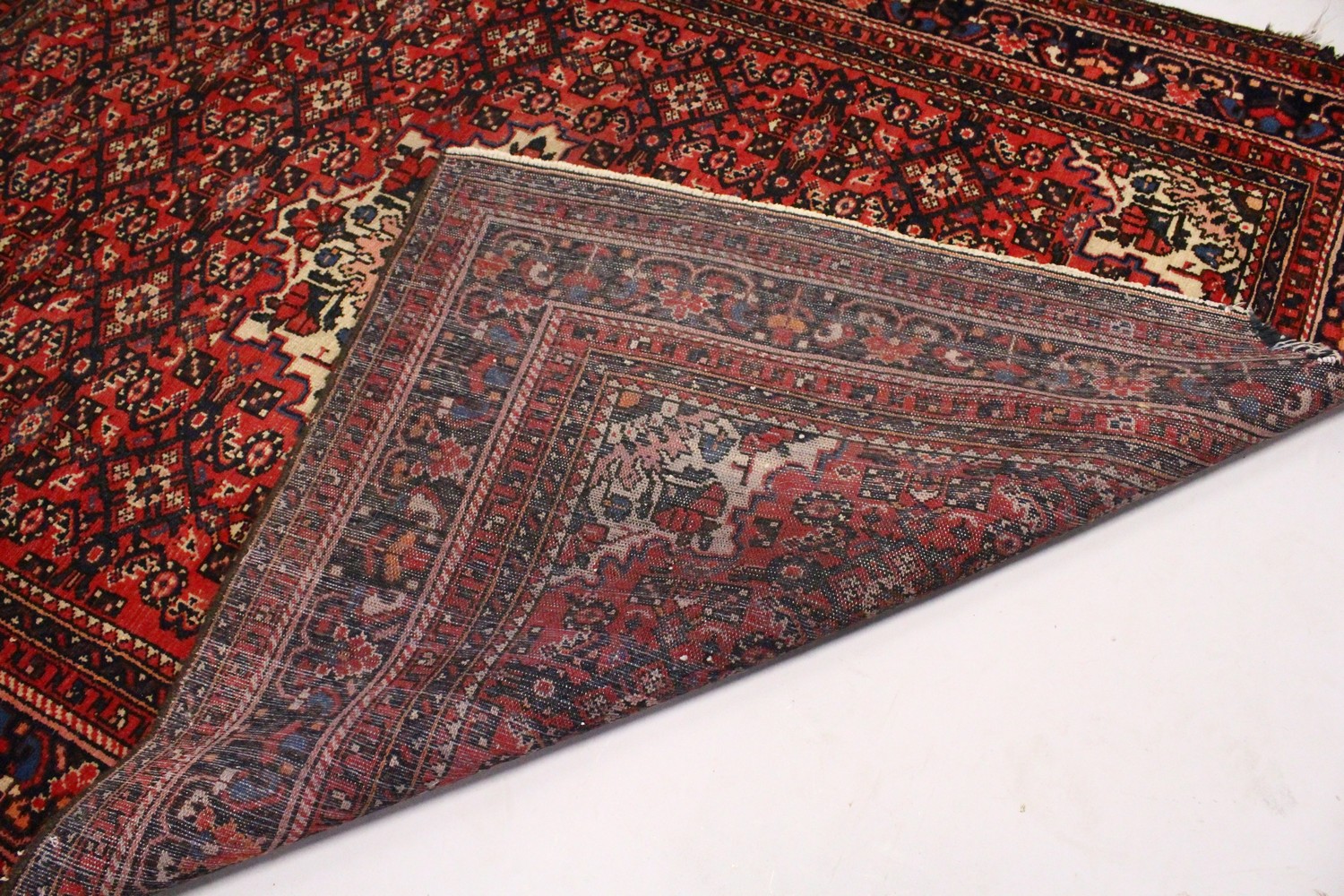 A PERSIAN RUG, 20TH CENTURY, red ground with central medallion, within a dark blue border. 6ft - Image 10 of 11