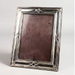 A SILVER PHOTOGRAPH FRAME. 8.5ins x 6ins.