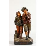 F. FOUCHER, "DU HAMEAU A L'ECOLE", a terracotta group of two children. Signed. 13ins high.