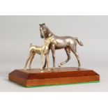 A SILVER PLATE MODEL OF A MARE AND FOAL, on a wooden base. 8ins long.