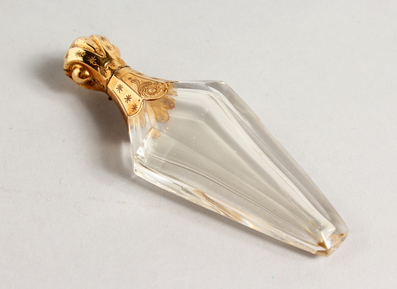 A GEORGIAN GLASS SCENT BOTTLE with gold top.