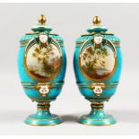 A VERY GOOD PAIR OF 19TH CENTURY SEVRES PORCELAIN VASES AND COVERS, with blue ground and painted