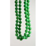 A STRING OF JADE BEADS. 34ins long.