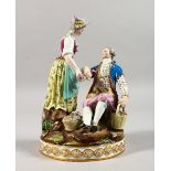 A 19TH CENTURY MEISSEN PORCELAIN GROUP OF A GALLANT AND LADY, carrying baskets of flowers, on a