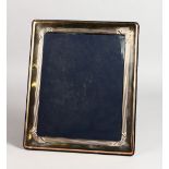 A LARGE SILVER RECTANGULAR PHOTOGRAPH FRAME. 11.5ins x 10ins.