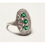 A SILVER ART DECO DESIGN FAUX EMERALD SET RING.