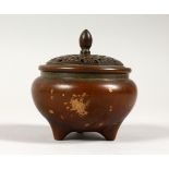 A SMALL BRONZE CIRCULAR CENSER, with pierced cover. 3ins diameter.