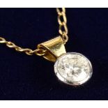 A DIAMOND PENDANT on a chain.